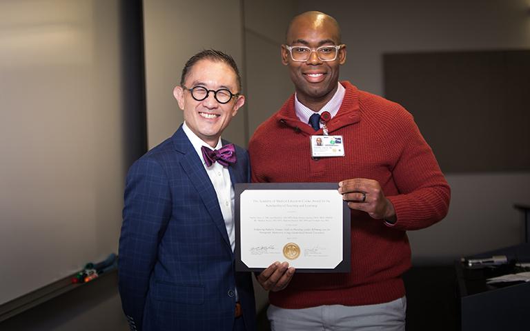 From left: AME member Kewchang Lee, MD presents Stanley Vance, MD with the 2019 Cooke Award for Scholarship. Photo by Elisabeth Fall.