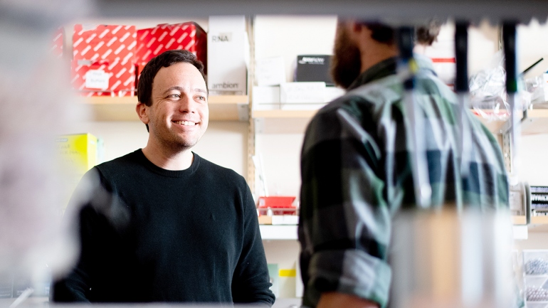 Zachary Knight (left), PhD, talks with graduate student Chris Zimmerman in his Mission Bay lab. Knight was named a Howard Hughes Medical Institute investigator. Photo by Noah Berger