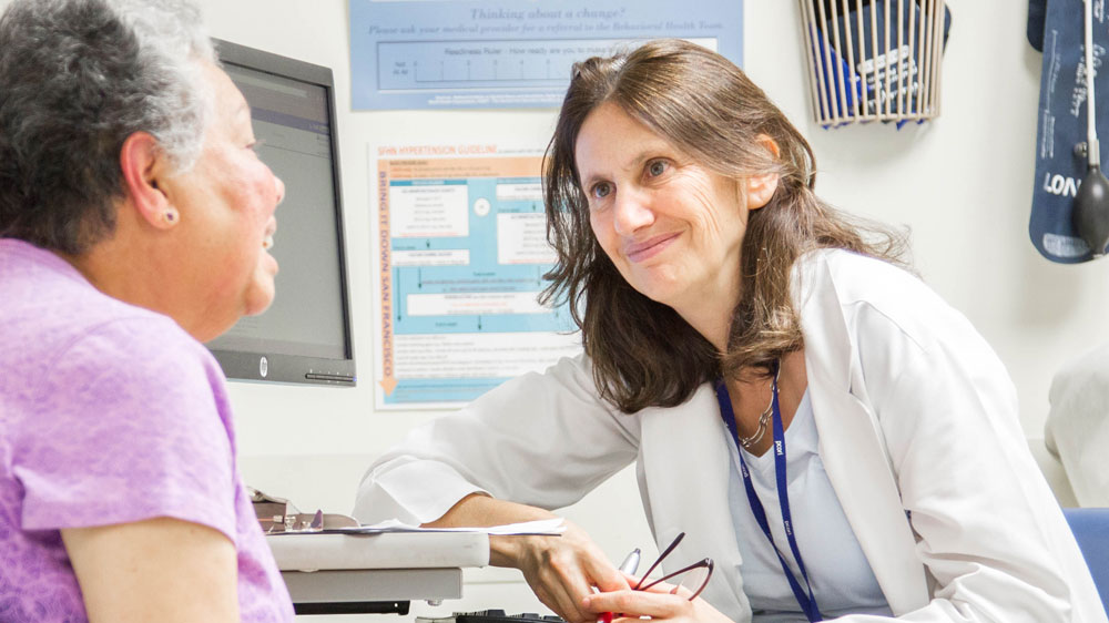 Alicia Fernandez, MD, meets with her long-time patient Ana Luianes at San Francisco General Hospital and Trauma Center (2015). Photo by Susan Merrell.