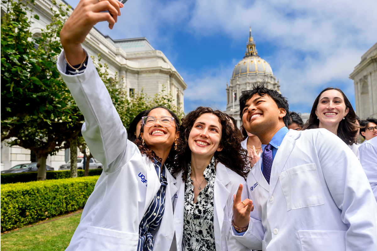 Members of the class of 2030 snap a selfie in front of San Francisco's iconic City Hall.