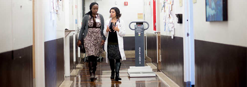 colleagues walk along a hallway