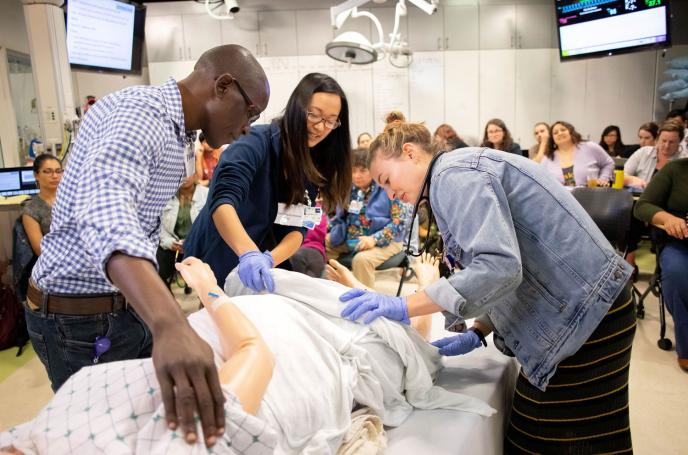 The UCSF School of Nursing's master's degree program and specialties were among the UCSF programs that placed highly in the latest U.S. News Best Grad School rankings. Nursing students, Emmanuel Onywera (left), Jennie Ling and Christina Camp (far right), learn how to care for an expectant mother using a simulation. Photo credit: Susan Merrell