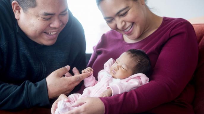 Newborn Elianna is held by her mother, Nichelle Obar, and father, Chris Constantino. Elianna was born in February at UCSF Medical Center at Mission Bay after receiving an in utero stem cell transplant to treat a lethal form of thalassemia. Photo by Barbara Ries