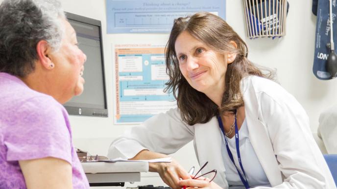 Alicia Fernandez, MD, meets with her long-time patient Ana Luianes at San Francisco General Hospital and Trauma Center (2015). Photo by Susan Merrell.