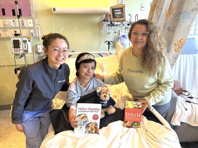 Dr. Claudia See, a second year Internal Medicine resident, with a cardiology patient and her mother who are looking forward to trying some heart-healthy recipes from their new cookbooks.