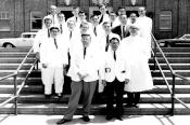 1963-1964 Chief Residents Rogers Mathews Vogelzang, MD, and Vincent Sing Yuen, MD, standing in front of gathering on ZSFG steps.
